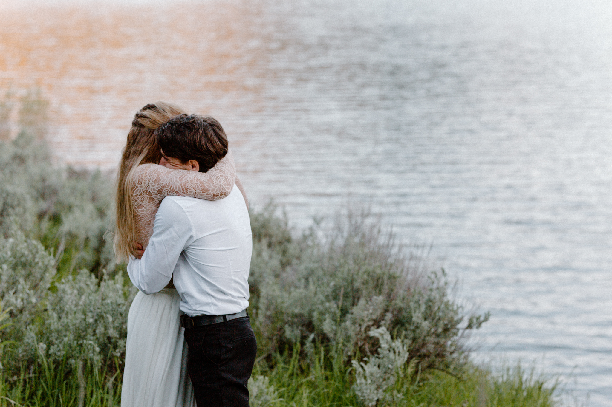 eloping couple hugs in Hyalite Reservoir