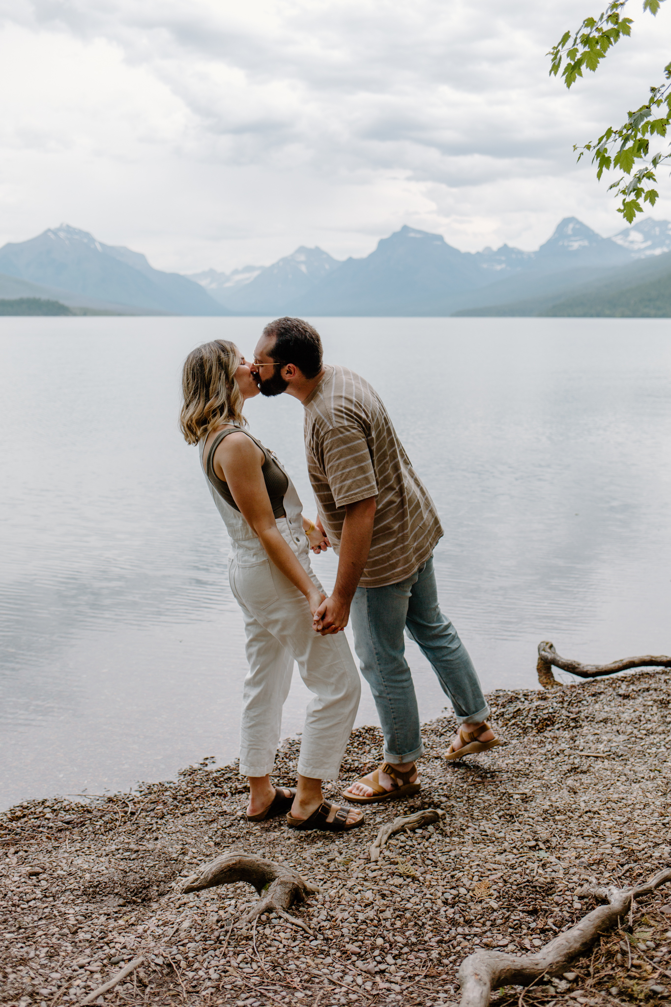 couple kisses at glacier national park engagement photos