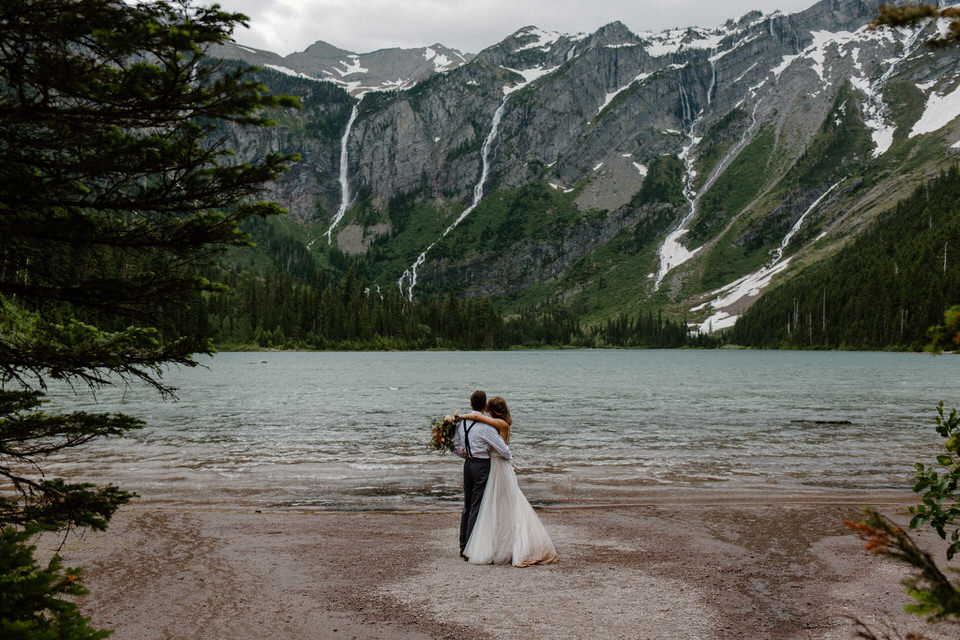 eloping couple hugs at avalanche lake