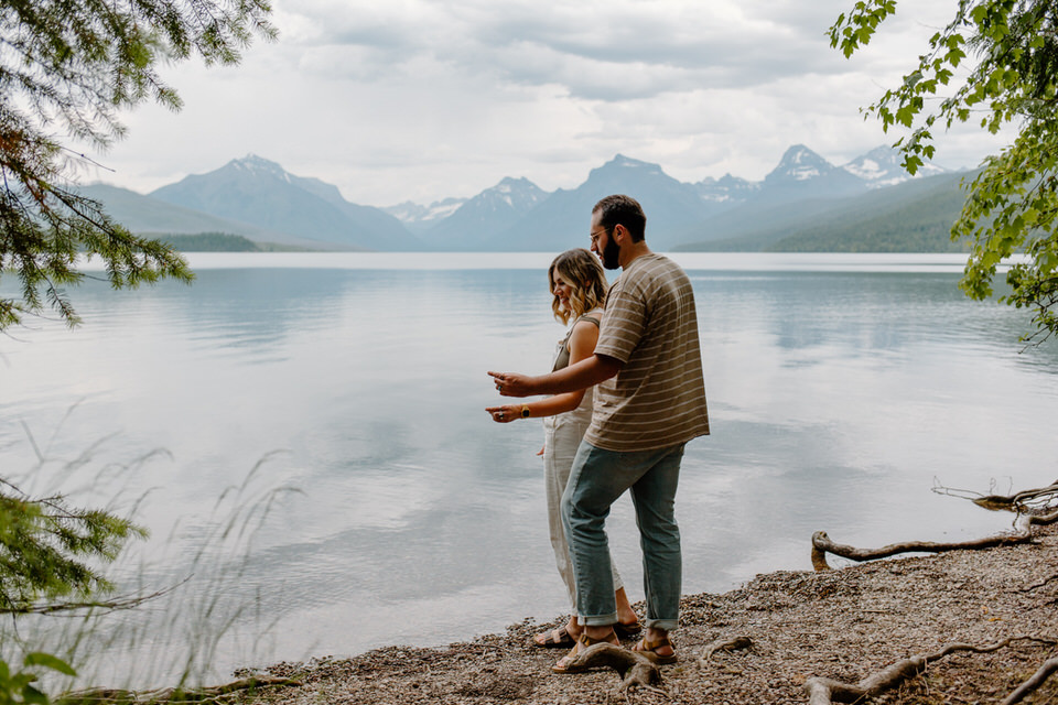 couple skips rocks at lake mcdonald montana