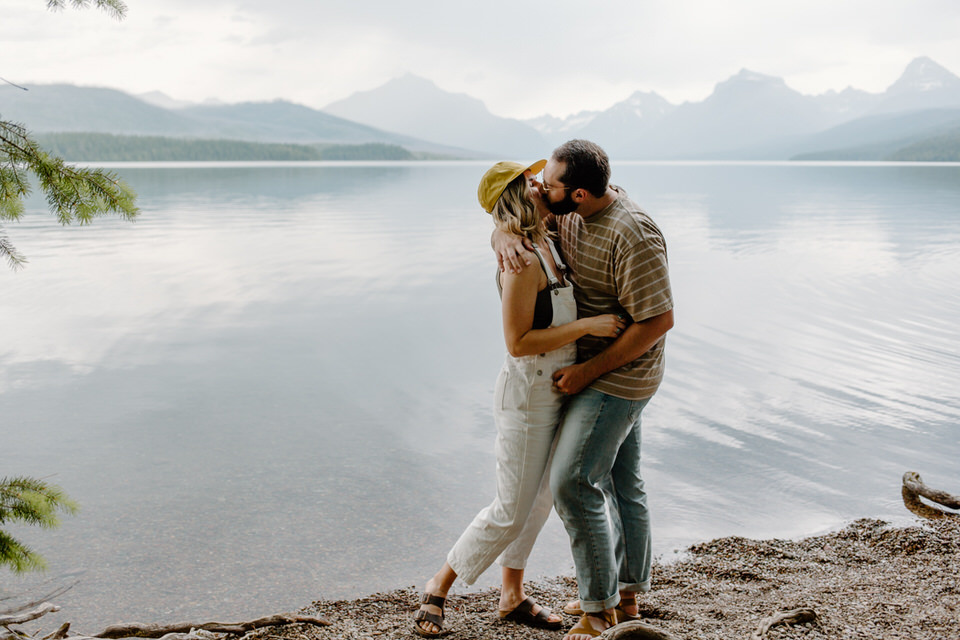 couple kisses at lake mcdonald