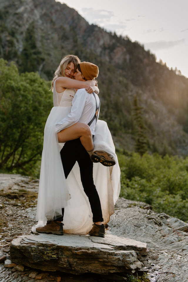 alternative wedding couple in front of mountain