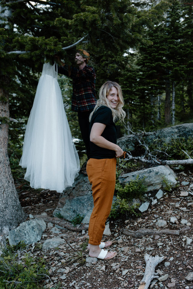 groom hangs up wedding dress in montana