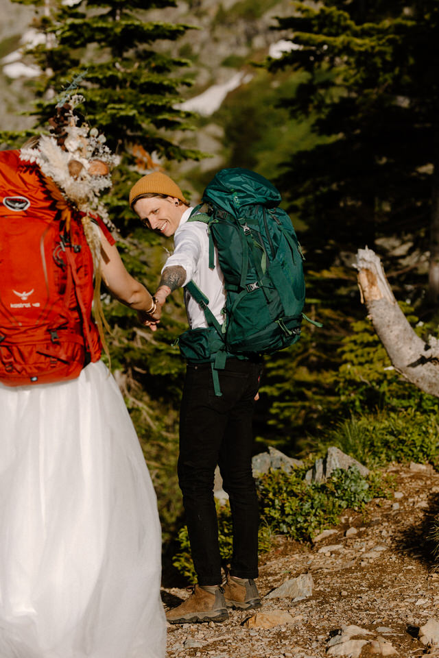 Groom elopement photo while backpacking