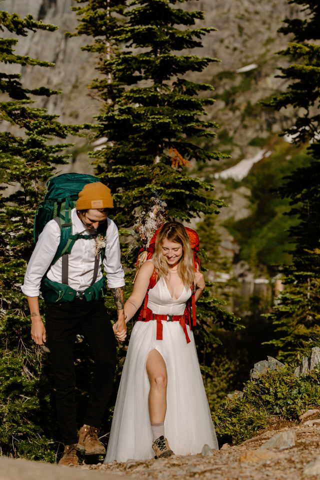 Bride and groom hike during elopement