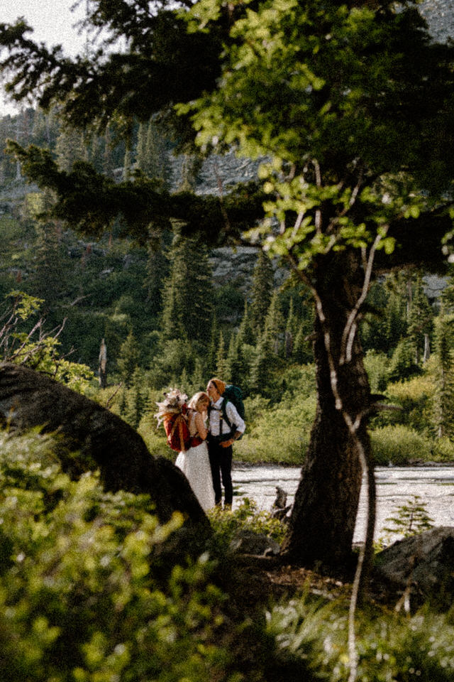 Couple backpacks during mountain elopement
