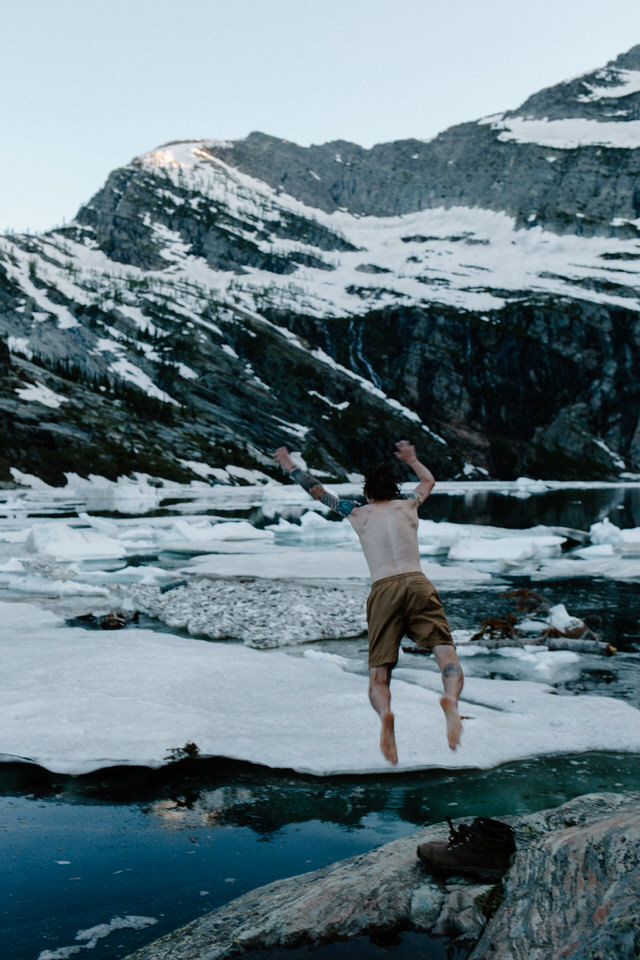 groom jumps off boulder into glacial lake