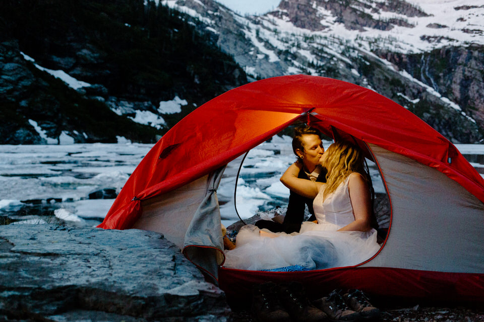 couple kisses in tent during sunrise at leigh lake