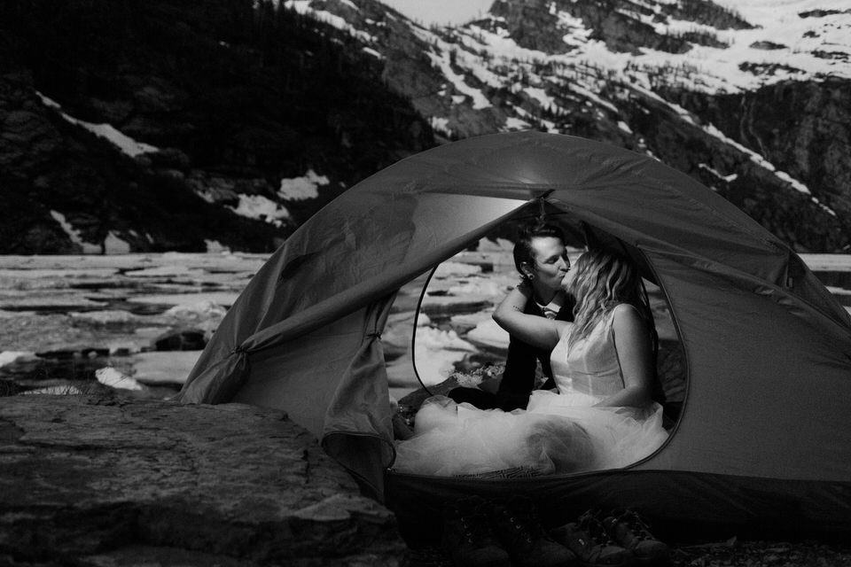 couple kisses in tent during montana elopement