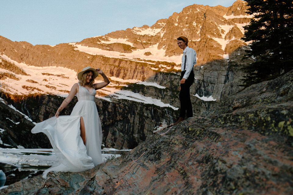bride shows off wedding dress in mountains