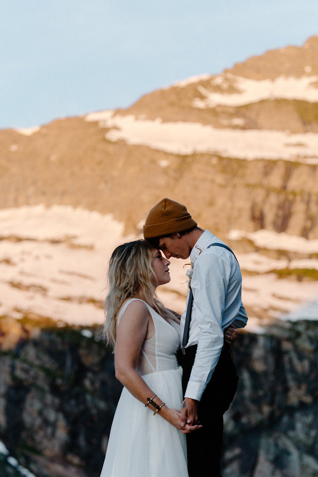 bride and groom hug in front of alpenglow