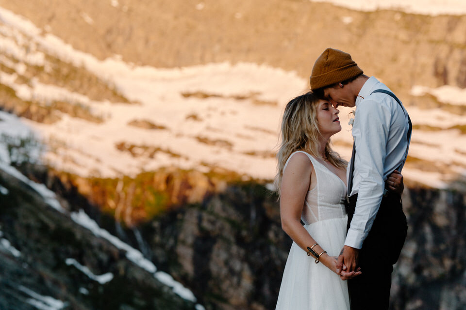 bride and groom hugs in front of mountain