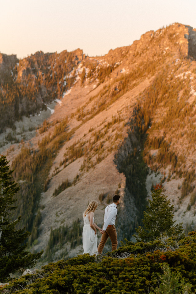 husband and wife climb mountain