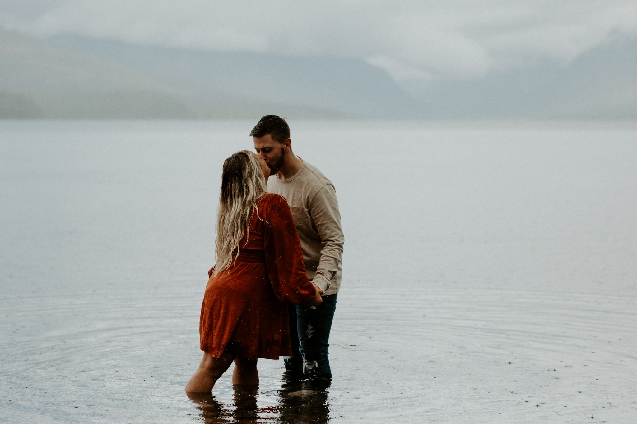 couple kisses at lake mcdonald glacier national park